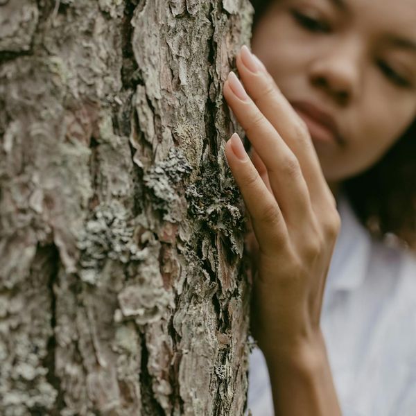 Person feeling serene and balanced in a natural setting.