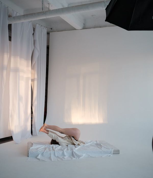 Woman performing a gentle morning exercise in a bright room.